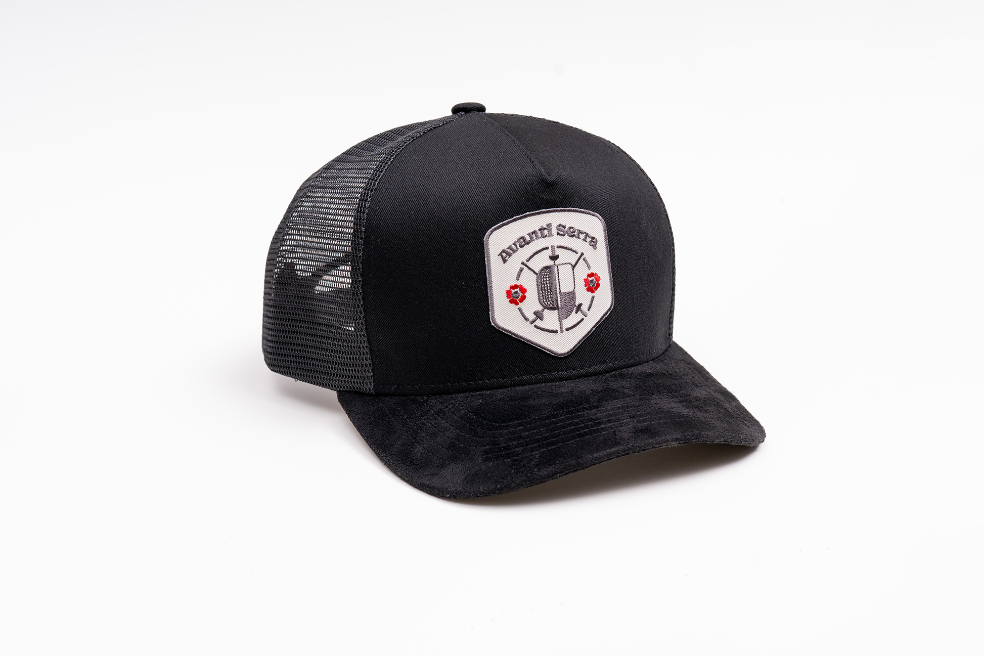 Close-up of embroidered patch on black trucker hat front panel